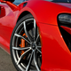 Close-up on the passenger-side front wheel of the 2023 McLaren Artura in Burnt Orange.